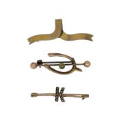 A trio of brooches, to include, a peridot wishbone style brooch, unhallmarked, stamped '9CT' with