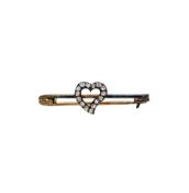 An Edwardian diamond heart brooch, length 4cm, unmarked tested as 9ct gold and silver, together with