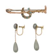 A gem set brooch and a pair of grey pearl earrings Yellow metal