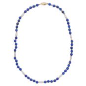 A lapis lazuli and pearl bead necklace Yellow metal