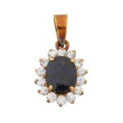 A sapphire and diamond halo pendant Yellow metal