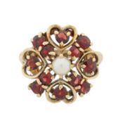 A garnet and pearl flower ring 9ct yellow gold