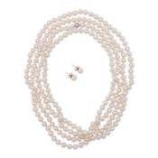 A long strand pearl necklace and earrings suite Yellow metal