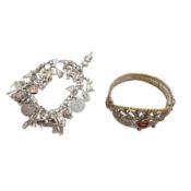 A silver charm bracelet and a carnelian bangle White metal