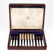 A canteen of silver and mother-of-pearl fruit knives and forks