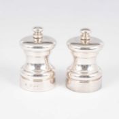 A pair of silver pepper mills