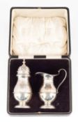 A silver sugar sifter and jug