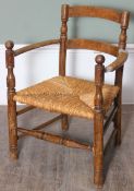 An Arts & Crafts period child's chair with rush seat, 46cm wide x 62cm tall