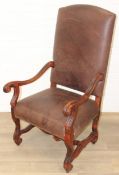 A 17th century style open armchair with a tall upholstered back and large proportioned seat, covered