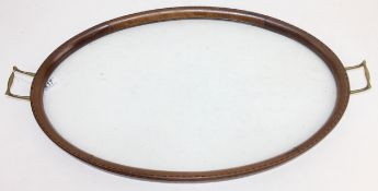An Edwardian Sheraton Revival serving tray with inlaid wooden edge, brass handles and glass