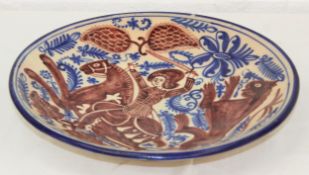 A large decorative ceramic charger depicting St George & The Dragon, possibly Spanish, named to
