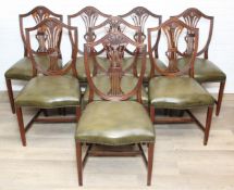 A set of eight Hepplewhite style mahogany dining chairs with shield backs, with green stuffed