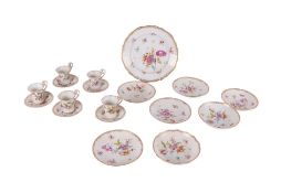 Five Dresden teacups and saucers decorated with flowers; together with a Dresden dish and shallow