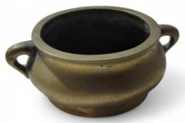 A bronze Chinese censer, of typical form with two