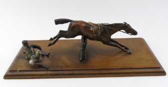 A patinated bronzed statuette paperweight and paper