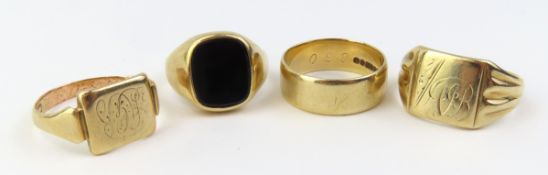 A group of four 9ct gold rings, including a 9ct go