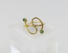 A stylised double cross over ring, set with two gr