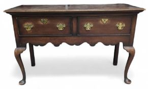A stained oak sideboard with two short drawers, ea