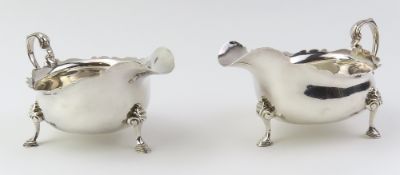 A pair of Britannia standard silver cream jugs