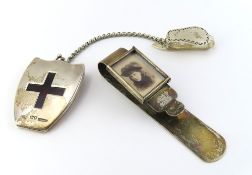 A silver chatelaine, comprising a shield shaped hin