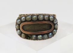A late Georgian mourning ring, set with a row of s
