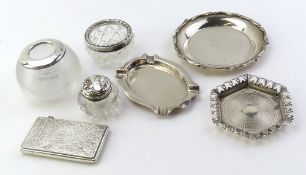 A collection of silver items, comprising three glass bottles
