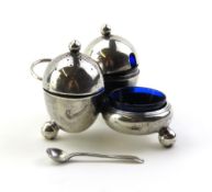 An interesting silver cruet set comprising three