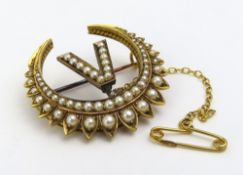 An unmarked pearl set half-moon crescent brooch, t