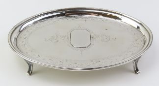 A silver Georgian card tray in an oval shape