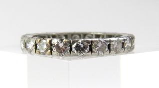 A diamond full eternity ring, unmarked white metal