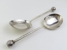 A pair of Victorian silver serving spoons of interesting