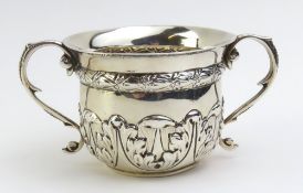 A silver porringer bowl with two ogee handles