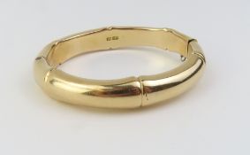A late 19th century hinged bamboo style bangle