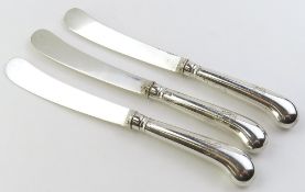 Three silver butter knives with silver handles