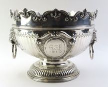 A very large silver punch bowl, with circular