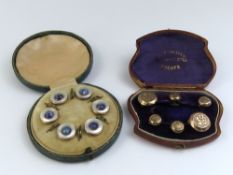 A set of six shirt buttons, four small and two lar