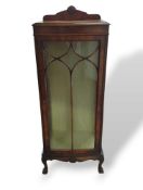 A mahogany shelving cabinet with glass door and gl
