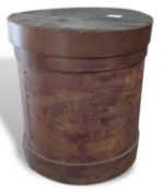 A cylindrical wooden pantry box stamped 