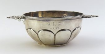 A silver quaich with decorative punched handles th