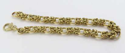A 9ct gold fancy link bracelet with a spring link