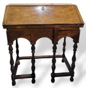 An interesting walnut inlaid bureau featuring four