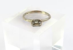 An 18ct white gold diamond solitaire ring, the eme