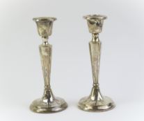A pair of small silver candlestick holders with so