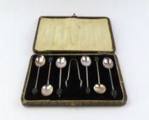 A cased set of six silver coffee spoons with a pai