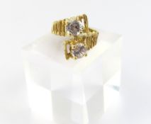 A cross over white stone ring, marked ‘14K’, the t
