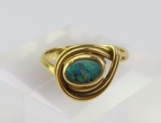 A gold opal set ring, marked ‘750’, the oval doubl