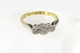A three stone diamond ring, the round stones are s