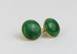 A pair of unmarked green jade earrings, the round