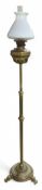 A tall brass oil lamp, with graduated circular bas