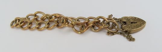 A 9ct gold oval curb link bracelet with a heart sh